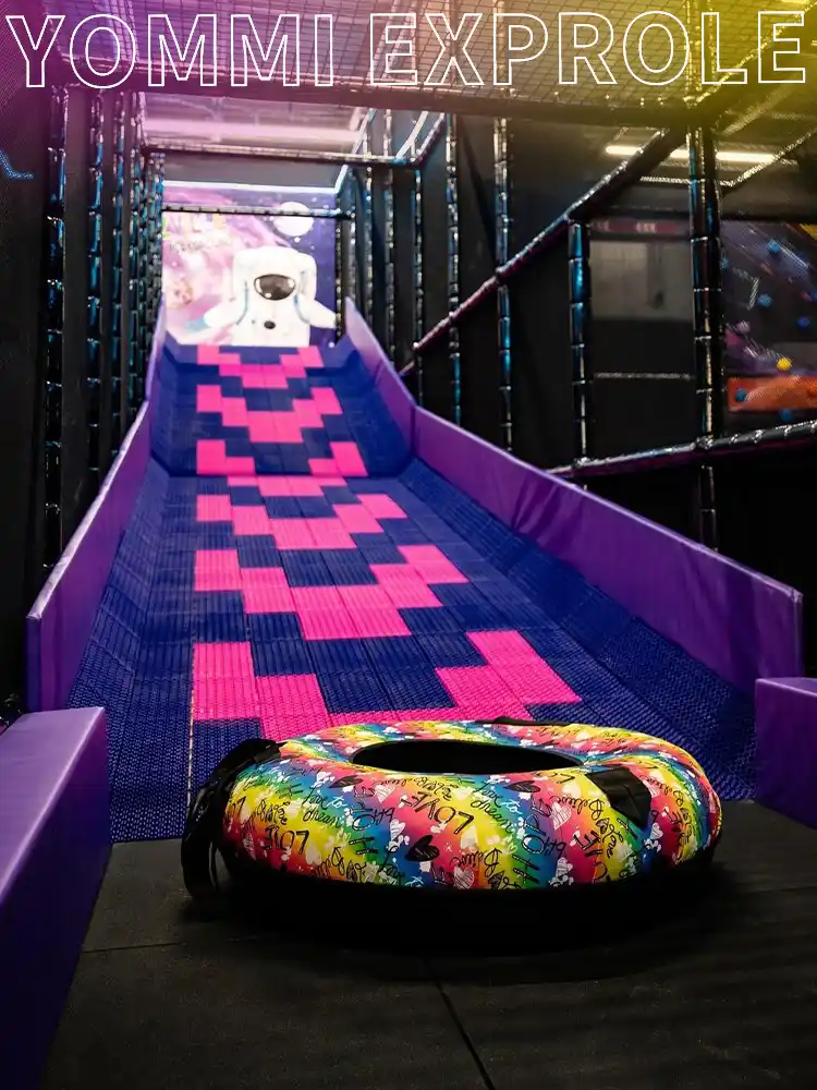 High-thrill dry snow drop slide with a custom snow tube, a core revenue-generating attraction for a commercial indoor playground.
