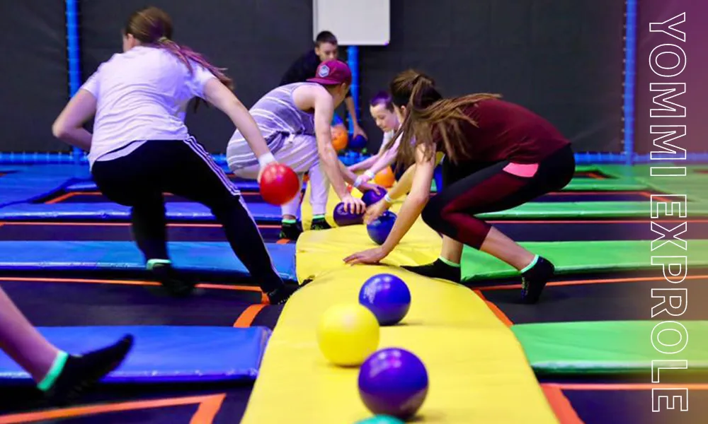 Action-packed extreme dodgeball arena in a commercial trampoline park, capitalizing on the Canadian preference for team-based contact sports.