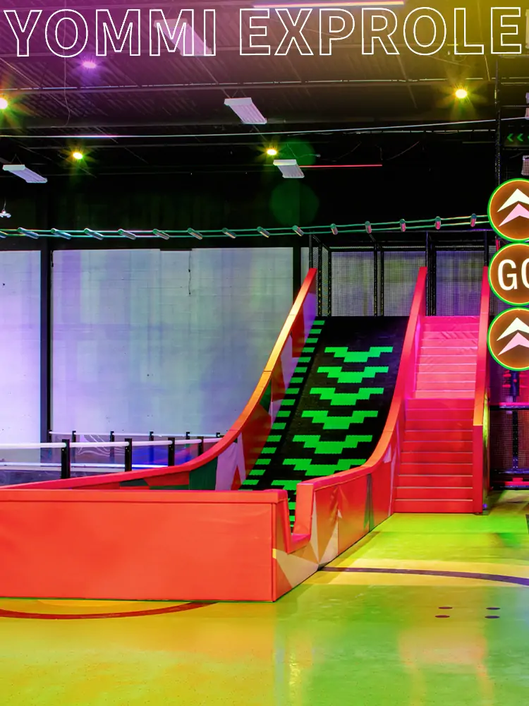 Extreme indoor slide attraction with industrial black aesthetics to attract the adult demographic.