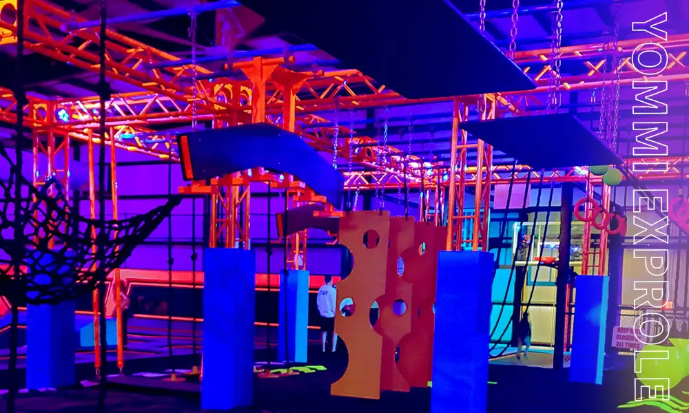 Cyberpunk style neon-lit Ninja Course engineered for adult stress resistance training and corporate events.