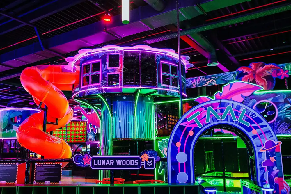 Neon spiral slide indoor playground equipment at Playtopia in Romania