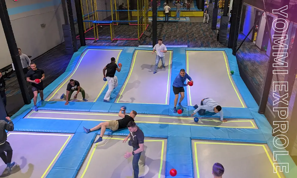 Competitive Sports Vibe neon-lit Ninja Course engineered for adult stress resistance training and corporate events.
