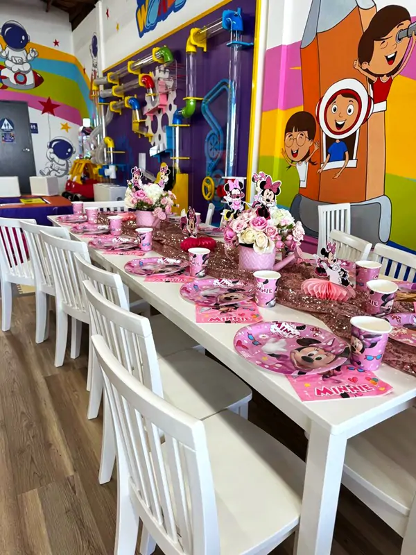 Beautifully decorated Minnie Mouse themed private party room table setup for kids birthdays
