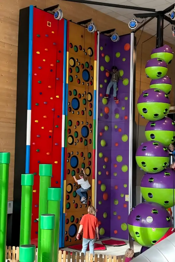 Kids climbing colorful walls at Speelpunt Zwevegem indoor playground