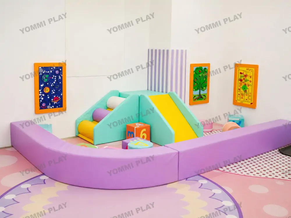 Independent safe infant soft play area at Babuland Banani boutique indoor playground, curved purple soft barrier separates toddlers from elder kids with mini slide and cognitive sensory wall games