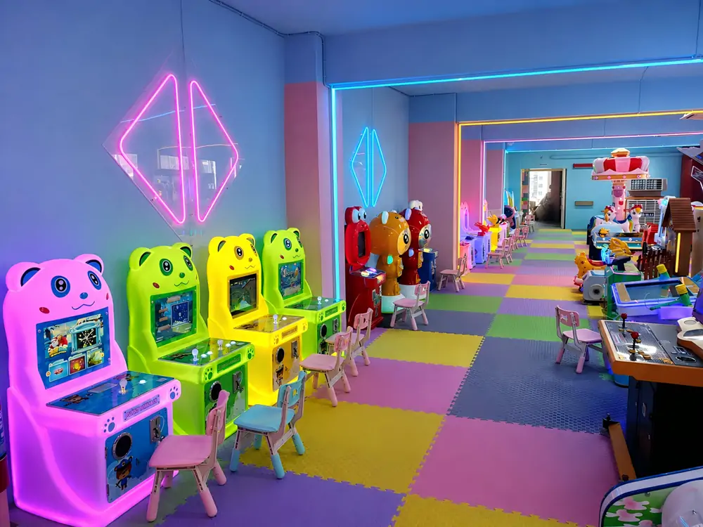 Colorful neon panda kids arcade machines and game station zone inside commercial indoor soft playground