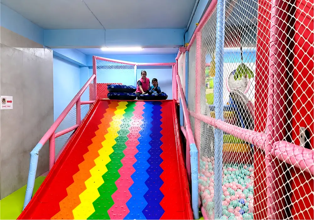 Rainbow donut slide soft playground equipment, popular kids attraction to boost weekend foot traffic and typical income earned for an indoor playground